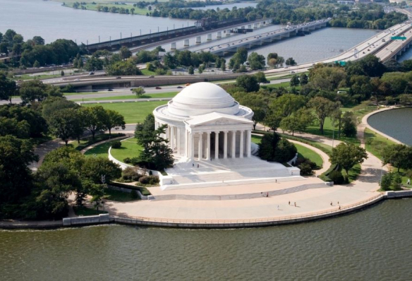 Aerial photograph of the newly restored Jefferson Memorial - gleaming white facade surrounded by a body of water.